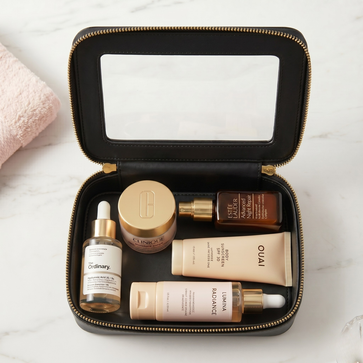 Single Zip Case in Black, styled with skincare on marble