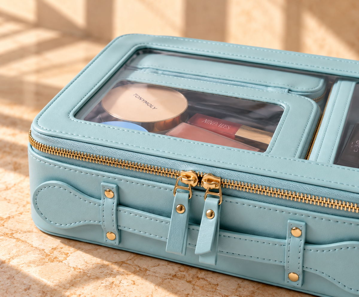 The 4-in-1 Case in Celestial Blue, close-up of gold zips and clear lid